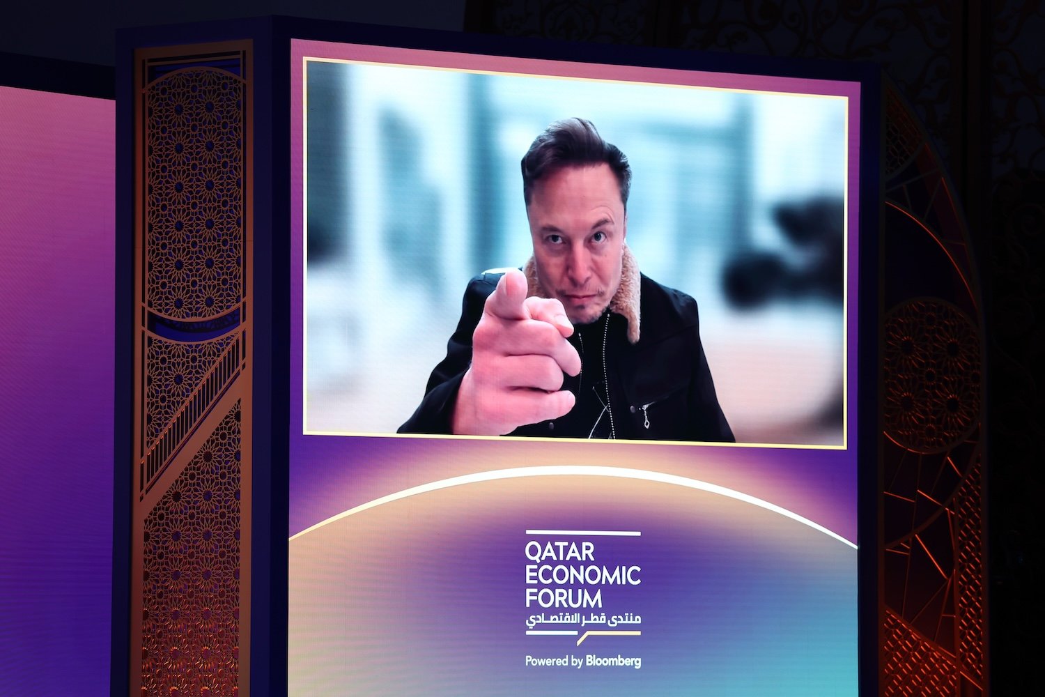 Elon Musk speaks via video link at the Qatar Economic Forum (QEF) in Doha, Qatar, on Tuesday, May 20, 2025.